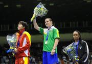 18 September 2010; Katie Taylor, Ireland, salutes the crowd after receiving her gold medal after her victory over Cheng Dong, China, silver medalist, during their 60kg Lightweight Final, also on the podium is Queen Underwood, USA, bronze medalist. AIBA Women World Boxing Championships Barbados 2010 - Finals, Garfield Sobers Sports Gymnasium, Bridgetown, Barbados. Picture credit: Stephen McCarthy / SPORTSFILE