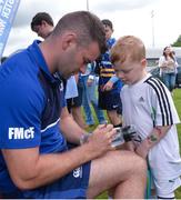 27 July 2016; Leinster's Fergus McFadden signs an autograph for Jack Gibney, aged 6, during the Bank of Ireland Leinster Rugby Summer Camp at Cill Dara RFC in Dunmurray West, Kildare. Photo by Piaras Ó Mídheach/Sportsfile