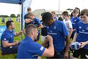 27 July 2016; Leinster's Fergus McFadden signs an autograph for Thomas Amoo, aged 12, from Kildare Town during the Bank of Ireland Leinster Rugby Summer Camp at Cill Dara RFC in Dunmurray West, Kildare. Photo by Piaras Ó Mídheach/Sportsfile