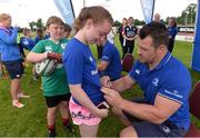27 July 2016; Leinster's Cian Healy signs an autograph for Mollie O'Riordan, age 12, during the Bank of Ireland Leinster Rugby Summer Camp at Cill Dara RFC in Dunmurray West, Kildare. Photo by Piaras Ó Mídheach/Sportsfile