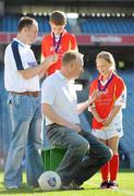 27 September 2010; 300 children from all over the country realised their dreams today when they got to play a match in the world-famous Croke Park stadium as part of the 2010 Vhi Cúl Day Out. The Vhi Cúl Day Out is a nationwide competition which was open to all 80,000 children who attended one of the 1000 Vhi GAA Cúl Camps held over the course of the summer. Today’s lucky 300 winners got to train and play a match in the world-famous stadium. GAA heroes such as Bernard Brogan, Anthony Daly and Eoin Kelly as well as other hurling, football, camogie and handball stars around the country were there to work with the children on the day to help them develop their skills and reinforce their passion for the game. Pictured is Megan Collins, age 10, from Baltimore, Co. Cork with Declan Moran, Director of Marketing and Business Development, VHI Healthcare and Oisin Mulvaney, age 10, from Killygary, Co. Cavan with Tipperary hurling captain Eoin Kelly. Vhi GAA Cúl Day Out 2010, Croke Park, Dublin. Picture credit: Brendan Moran / SPORTSFILE