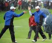 1 October 2010; Graeme McDowell, Team Europe, celebrates his bunker shot on the 4th green with playing partner Rory Mcllroy during their first round fourball match against Stewart Cink and Matt Kuchar, Team USA. The 2010 Ryder Cup, The Celtic Manor Resort, City of Newport, Wales. Picture credit: Matt Browne / SPORTSFILE