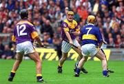 12 August 2001; Garry Laffan of Wexford passes the ball to team-mate Rory McCarthy, left, under pressure from Eamon Corcoran of Tipperary during the Guinness All-Ireland Senior Hurling Championship Semi-Final match between Wexford and Tipperary at Croke Park in Dublin. Photo by Brian Lawless/Sportsfile