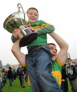 10 October 2010; Joe Kilmurray, Rhode, celebrates with Aaron Kellaghan, aged 10, and the Dowling Cup after the game. Offaly County Senior Football Championship Final, Rhode v Clara, O'Connor Park, Tullamore, Co. Offaly. Photo by Sportsfile