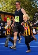 25 October 2010; Colum Sheridan, Kilmacow, Co. Kilkenny, on the approach to the finish line with his children David, age 4, and Rose, age 6, during the Lifestyle Sports - adidas Dublin Marathon 2010. Dublin. Picture credit: Stephen McCarthy / SPORTSFILE