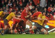 16 November 2010; Billy Holland, Munster, is tackled by Dean Mumm, right, and Nick Phipps, Australia. Sony Ericsson Challenge, Munster v Australia, Thomond Park, Limerick. Picture credit: Diarmuid Greene / SPORTSFILE