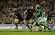 20 November 2010; Mils Muliaina, New Zealand, goes past the tackle of Gordon D'Arcy, Tom Court and Eoin Reddan, Ireland. Autumn International, Ireland v New Zealand, Aviva Stadium, Lansdowne Road, Dublin. Picture credit: Matt Browne / SPORTSFILE