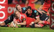 21 November 2010; Paul Warwick, Munster, goes over for his side's first try despite the best efforts of Morgan Stoddart, left, and Aaron Shingler, Llanelli Scarlets. Celtic League, Munster v Llanelli Scarlets, Musgrave Park, Cork. Picture credit: Brendan Moran / SPORTSFILE