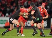 21 November 2010; Sam Tuitupou, Munster, is tackled by Rhys Priestland, left, and Jonathan Edwards, Llanelli Scarlets. Celtic League, Munster v Llanelli Scarlets, Musgrave Park, Cork. Picture credit: Brendan Moran / SPORTSFILE