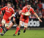 21 November 2010; James Coughlan, Munster, is tackled by Iestyn Thomas, Llanelli Scarlets. Celtic League, Munster v Llanelli Scarlets, Musgrave Park, Cork. Picture credit: Brendan Moran / SPORTSFILE