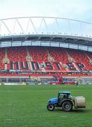 4 December 2010; Groundstaff remove bales of hay, which was used to protect the pitch from the recent cold weather, before the game. Celtic League, Munster v Cardiff Blues, Thomond Park, Limerick. Picture credit: Brendan Moran / SPORTSFILE