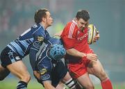 4 December 2010; Damien Varley, Munster, is tackled by Mike Paterson and Dan Parks, left, Cardiff Blues. Celtic League, Munster v Cardiff Blues, Thomond Park, Limerick. Picture credit: Brendan Moran / SPORTSFILE