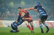 4 December 2010; Johne Murphy, Munster, is tackled by Sam Warburton, left, and Mike Paterson, Cardiff Blues. Celtic League, Munster v Cardiff Blues, Thomond Park, Limerick. Picture credit: Brendan Moran / SPORTSFILE