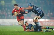 4 December 2010; Johne Murphy, Munster, is tackled by Sam Warburton, left, and Mike Paterson, Cardiff Blues. Celtic League, Munster v Cardiff Blues, Thomond Park, Limerick. Picture credit: Brendan Moran / SPORTSFILE