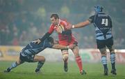 4 December 2010; Johne Murphy, Munster, is tackled by Sam Warburton, left, and Mike Paterson, Cardiff Blues. Celtic League, Munster v Cardiff Blues, Thomond Park, Limerick. Picture credit: Brendan Moran / SPORTSFILE