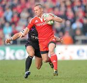 12 December 2010; Paul Warwick, Munster, is tackled by James Hook, Ospreys. Heineken Cup Pool 3 - Round 3, Munster v Ospreys, Thomond Park, Limerick. Picture credit: Matt Browne / SPORTSFILE