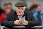 15 December 2010; A punter reads the form on the race card before The John Durkan Memorial Punchestown Steeplechase. Fairyhouse Racecourse, Fairyhouse, Co. Meath. Picture credit: Barry Cregg / SPORTSFILE