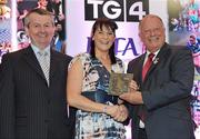 15 December 2010; TG4 celebrated their tenth year as sponsor of the Ladies Football Championships last night at a Banquet in Croke Park and in honour of the association between TG4 and Ladies Football, the TG4 Ladies Football Team of the Decade was announced. Receiving her award as a member of the team from Pat Quill, right, President, Cumann Peil Gael na mBan and Pol O Gallchoir, Ceannasai, TG4, is Briege Corkery of Cork. TG4 Ladies Football Team of the Decade Banquet, Croke Park, Dublin. Picture credit: Brendan Moran / SPORTSFILE