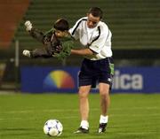 14 November 2001; Gary Kelly entertains Iranian boy Fariz Lafiz, aged 3, after a Republic of Ireland Squad Training Session at the Azadi Stadium in  Tehran, Iran. Photo by Brendan Moran/Sportsfile