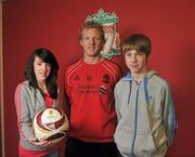 14 March 2011; Pictured is Liverpool FC’s Dirk Kuyt, with Dublin’s Liam Scully, age 13, and Ciara O’Meara, age 14, at the launch of the adidas / Elverys Sports Europa League Final Competition. The winner, who must be aged between 10 and 14, will get the once in a lifetime opportunity to deliver the match ball at the Europa League Final in Dublin on 18th May. To enter, please see details in store at Elverys Sports. For further information visit www.elverys.ie. Mellwood Training Ground, Liverpool, England. Picture credit: David Maher / SPORTSFILE