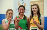 19 March 2011; U17 Girls 1500m winner Ellen Moran, Westport AC, Co. Mayo, centre, with second place Ellen O'Hanlon, Raheny Shamrocks AC, Dublin, left, and third place Laura Young, Annalee AC, Co. Cavan. Woodie’s DIY National Juvenile Indoor Championships, Meadowbank Indoor Arena, Magherafelt, Derry. Picture credit: Oliver McVeigh / SPORTSFILE