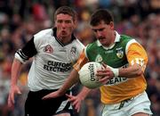 2 August 1998; Mel Keeghan of Offaly is tackled by Jimmy Hayes of Sligo during the All-Ireland Junior Football Championship Semi-Final between Offaly and Sligo at Dr Hyde Park in Roscommon. Photo by Matt Browne/Sportsfile