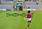 17 March 2011; Clarinbridge mascot Cian Donoghue, age 6, son of team manager Micheál, runs out to the bench before the team photograph. AIB GAA Hurling All-Ireland Senior Club Championship Final, Clarinbridge v O’Loughlin Gaels, Croke Park, Dublin. Picture credit: Brendan Moran / SPORTSFILE