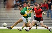 10 April 2011; Eoin Brosnan, Kerry, has a shot on goal despite the attentions of Paul McComiskey, Down. Allianz Football League, Division 1, Round 7, Kerry v Down, Fitzgerald Stadium, Killarney, Co. Kerry. Picture credit: Brendan Moran / SPORTSFILE