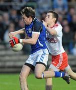 13 April 2011; Niall Murray, Cavan, evades the tackle of Richard Donnelly, Tyrone, to score his side's first goal. Cadbury Ulster GAA Football Under 21 Championship Final, Cavan v Tyrone, Brewster Park, Enniskillen, Co. Fermanagh. Picture credit: Oliver McVeigh / SPORTSFILE