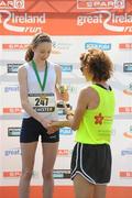 10 April 2011; Lorraine Daly, from Ture, Co. Donegal, receives her third place trophy from Sonia O'Sullivan following the SPAR Junior Great Ireland Run 2011. Phoenix Park, Dublin. Picture credit: Stephen McCarthy / SPORTSFILE