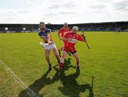 17 April 2011; Eamon Kearnes clears up field for Wicklow, in the dying seconds of the game, under pressure from Michael Kirpatrick, Derry. Allianz GAA Hurling Division 3A Final, Wicklow v Derry, Pearse Park, Longford. Picture credit: Ray McManus / SPORTSFILE