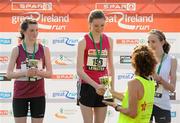 10 April 2011; Cassie Murphy, from Dundrum, Co. Dublin, receives her winners trophy from Sonia O'Sullivan following the SPAR Junior Great Ireland Run 2011. Phoenix Park, Dublin. Picture credit: Stephen McCarthy / SPORTSFILE