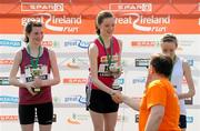 10 April 2011; Girls winner Cassie Murphy, from Dundrum, Co. Dublin, is congratulated by Eddie Hobbs following the SPAR Junior Great Ireland Run 2011. Phoenix Park, Dublin. Picture credit: Stephen McCarthy / SPORTSFILE