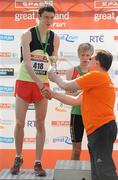 10 April 2011; Eoin Taggart, from Blessington, Co. Wicklow, is presented with his trophy by Eddie Hobbs following the SPAR Junior Great Ireland Run 2011. Phoenix Park, Dublin. Picture credit: Stephen McCarthy / SPORTSFILE