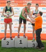 10 April 2011; First place David Harper, from Westport, Co. Mayo, is presented with his trophy by Eddie Hobbs following the SPAR Junior Great Ireland Run 2011. Phoenix Park, Dublin. Picture credit: Stephen McCarthy / SPORTSFILE