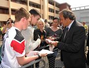 19 April 2011; UEFA President Michel Platini signs autographs after he had visited the Hardwicke F.C. club's facilities and the Football for All Programme while in Dublin for the UEFA Europa League Trophy Handover in advance of the UEFA Europa League final, to be played at the Aviva Stadium on Wednesday 18 May. Hardwicke Street, Dublin. Picture credit: Ray McManus / SPORTSFILE
