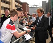 19 April 2011; UEFA President Michel Platini signs autographs after he had visited the Hardwicke F.C. club's facilities and the Football for All Programme while in Dublin for the UEFA Europa League Trophy Handover in advance of the UEFA Europa League final, to be played at the Aviva Stadium on Wednesday 18 May. Hardwicke Street, Dublin. Picture credit: Ray McManus / SPORTSFILE