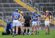 17 April 2011; Tipperary's Shane McGrath is attended to after injuring himself. Allianz Hurling League, Division 1, Round 7, Tipperary v Wexford, Semple Stadium, Thurles, Co. Tipperary. Picture credit: Brian Lawless / SPORTSFILE