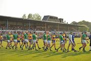 30 April 2011; Limerick and Clare players walk side by side during the parade before the start of the game. Allianz Hurling League Division 2 Final, Clare v Limerick, Cusack Park, Ennis, Co. Clare. Picture credit: David Maher / SPORTSFILE