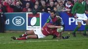 5 January 2002; Dominic Crotty of Munster goes over for his try despite the tackle of Matt Moore of Harlequins during the Heineken Cup Pool 4 Round 5 match between Munster and Harlequins at Thomond Park in Limerick. Photo by Matt Browne/Sportsfile