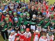 10 May 2011; Dublin National Hurling League winner Liam Ryan marks the beginning of 'Camán Let’s Play', a hurling initiative organised by Parnell’s GAA Club to promote hurling and encourage participation among local Dublin schools. With over 220 children, ranging from 7yrs – 12yrs due to take part, the competition will be based on a round robin series of games, supported by eFlow and at no expense to the participating schools. Pictured at the launch is Liam Ryan, centre right, and Simon McBeth, eFlow, centre left, with participating children. Launch of 'Camán Let’s Play', supported by eFlow, Astro Park, Coolock, Dublin. Picture credit: Brian Lawless / SPORTSFILE