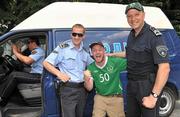 3 June 2011; Republic of Ireland supporter David Donegan, from Dolphins Barn, Dublin, with members of the Macedonian police force in Skopje ahead of the EURO2012 Championship Qualifier against Macedonia on Saturday. Skopje, Macedonia. Picture credit: David Maher / SPORTSFILE