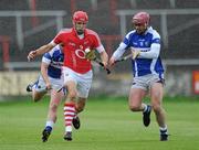 18 June 2011; Pa Cronin, Cork, in action against James Walsh and Owen Holohan, right, Laois. GAA Hurling All-Ireland Senior Championship Preliminary Round, Laois v Cork, O'Moore Park, Portlaoise, Co. Laois. Picture credit: Matt Browne / SPORTSFILE