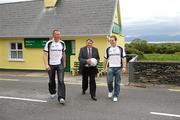 4 July 2011; Former England and Aston Villa football manager Graham Taylor crosses the main street in Glenbeigh, Co. Kerry, with Kerry footballers Kieran Donaghy, left, and Darran O'Sullivan at the Newstalk 106-108 FM’s Off the Ball exclusive live broadcast of Ireland’s most popular sports radio show ‘Off the Ball’ at The Towers Pub, Glenbeigh, Co. Kerry, on Monday July 4th. The live broadcast is part of the ‘Off the Ball Roadshow with Ulster Bank’ which gives people an opportunity to see the hit show broadcast live from popular GAA haunts across the country throughout the 2011 All-Ireland Senior Championships. Ulster Bank is also celebrating its three-year extended sponsorship of the GAA Football All-Ireland Championship with the introduction of a major new club focused initiative, called ‘Ulster Bank GAA Force’. The initiative will support local GAA clubs across the country by giving them the opportunity to refurbish and upgrade their facilities. For further information, checkout www.ulsterbank.com/gaa. Off the Ball Roadshow with Ulster Bank, The Towers Pub, Glenbeigh, Co. Kerry. Picture credit: Brendan Moran / SPORTSFILE