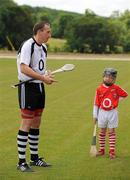 2 July 2011; Cork Senior Hurler John Gardiner is watched by Kevin O'Sullivan, age 8, from Inishannon, Co. Cork, while speaking to competition winners during a specially organised training drill. The winners were chosen from a week long competition on Red FM in association with O2 and O'Neill's and got to take part in a training session with the Cork squad in Doneraile GAA club ahead of their next game in the championship. Doneraile, Cork. Picture credit: Brendan Moran / SPORTSFILE