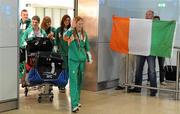 11 July 2011; Ireland's Kate Veale, Gold Medallist in the Girls 5000m Walk, followed by team-mates Marcus Lawler, Shane Fitzsimons, Megan Kiely and Philippa Hogan, is cheered on by her uncle Eamonn Veale, from Abbeyside, Dungarvan, Co. Waterford, in Dublin Airport as the Irish Team returns from IAAF World Youth Championships. Dublin Airport, Dublin. Picture credit: Brendan Moran / SPORTSFILE