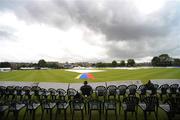 11 July 2011; A spectator waits for play to begin as the match is delayed due to rain. One Day International, Ireland v Sri Lanka, Citylets Grange, Edinburgh, Scotland. Picture credit: Ian Jacobs / SPORTSFILE