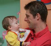 6 March 2002; Republic of Ireland international Niall Quinn with 8 month old William Geraghty from, Clondalkin, Dublin, at Our Lady's Hospital for Sick Children in Crumlin in Dublin. Photo by David Maher/Sportsfile