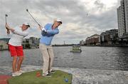 3 August 2011; Two of the best female golfers in the world went head-to-head today in an unusual golf dual in Dublin’s Grand Canal Dock to mark 50 days to The 2011 Solheim Cup. In an early victory for Europe, England’s Melissa Reid, right, beat American Stacey Lewis, left, as the two professionals pitched out into a floating target in the water in front of lucky spectators who then got to attempt the shot for themselves. In just 50 days Ireland will stage the biggest international sporting event of 2011, when Europe takes on the USA for The 2011 Solheim Cup in Killeen Castle, county Meath this September 23rd to 25th. A host of Solheim Cup candidates are taking advantage of this week’s Ladies Irish Open, supported by Fáilte Ireland, which is also being played on the Jack Nicklaus Signature Course at Killeen Castle. For the latest information, and to purchase tickets for The 2011 Solheim Cup, visit - www.solheimcup.com. Grand Canal Dock, Dublin. Picture credit: Brian Lawless / SPORTSFILE