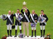 5 August 2011; Chef d'Equipe Rob Hoekstra lifts the Aga Khan trophy with his victorious Great Britain team from left, Michael Whitaker, Robert Smith, Nick Skelton and Scott Brash after winning the Aga Khan Day trophy at the Dublin Horse Show 2011. Main Arena, RDS, Ballsbridge, Dublin. Picture credit: Barry Cregg / SPORTSFILE